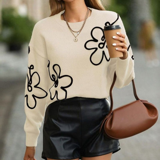 Sweater i one size. Sweateren er i beige, med sorte blomster på 